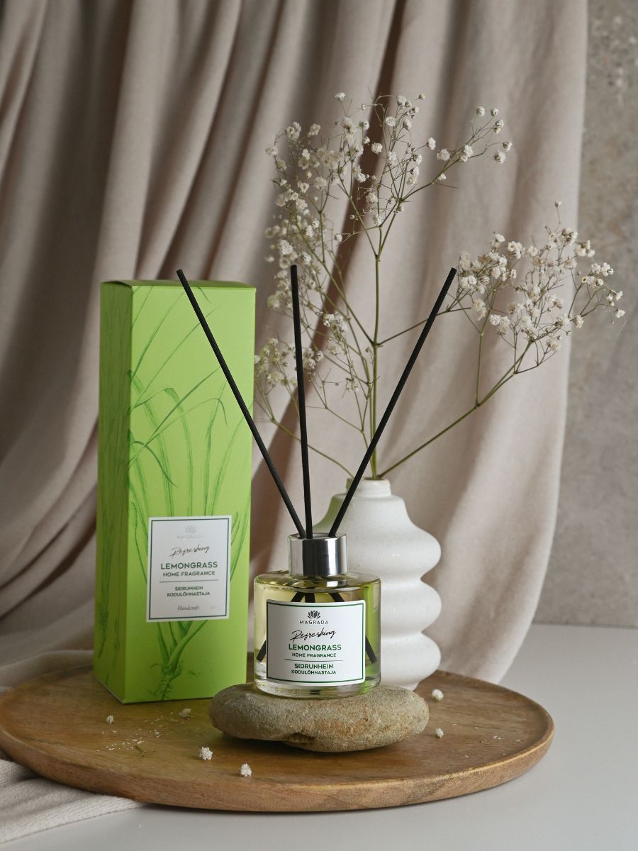 Magrada Organic Cosmetics lemongrass home fragrance diffuser with black reeds and green packaging displayed on wooden tray