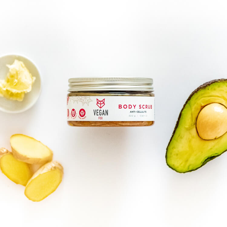 Vegan Fox ginger anti-cellulite scrub jar with fresh ginger slices avocado and butter on white background