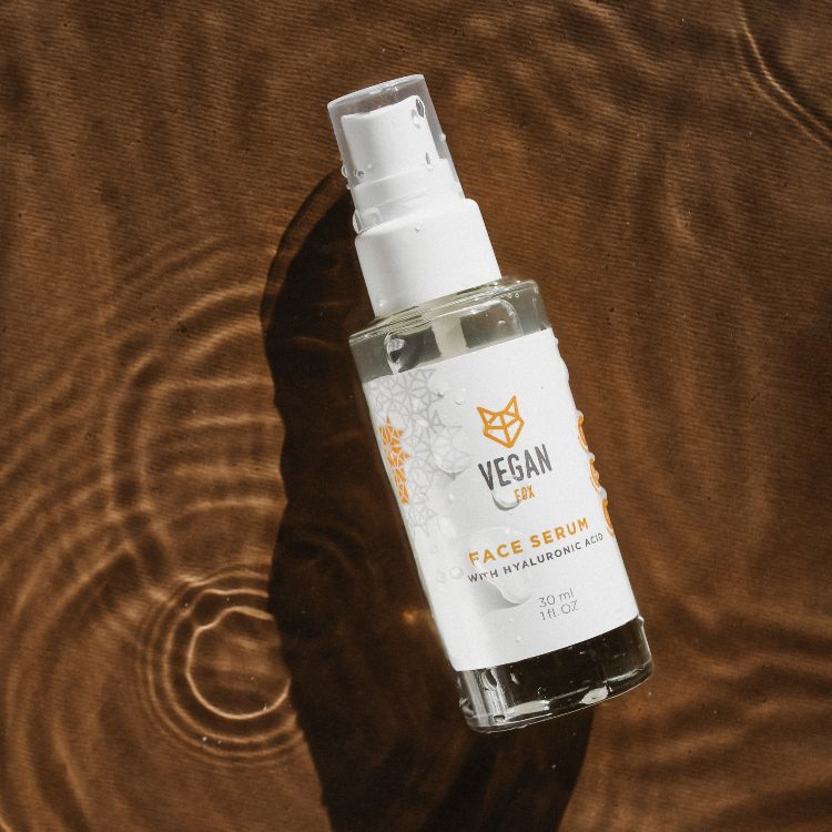 Vegan Fox Hyaluronic Acid Face Serum in clear pump bottle on brown textured surface