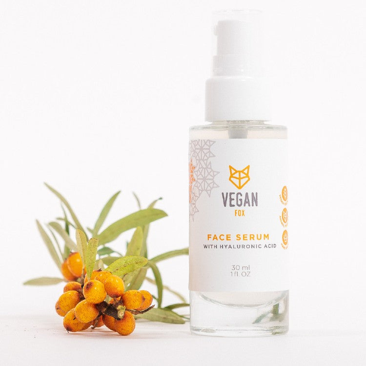 Vegan Fox Hyaluronic Acid Face Serum in clear pump bottle with sea buckthorn berries on white background