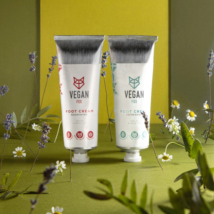 Vegan Fox hydrating foot cream 120ml tubes placed among green plants and flowers